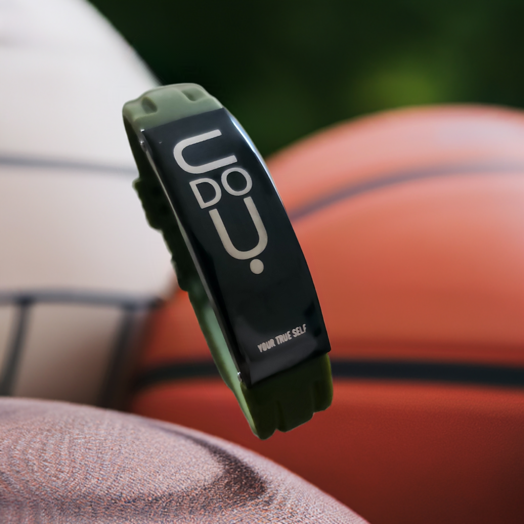 BRACELET UDOYU Grey mood resting on sports balls, showcasing unique design and message of authenticity.
