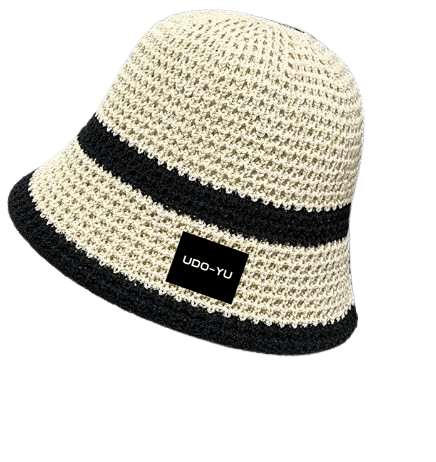 Handmade crochet bucket hat in cream and black with adjustable brim, perfect for sunny days and stylish comfort.