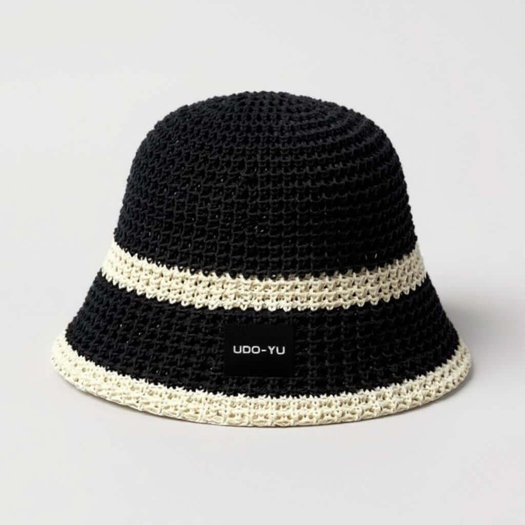 Handmade crochet bucket hat in black with white stripes, adjustable brim for comfort and style, perfect for sunny days.